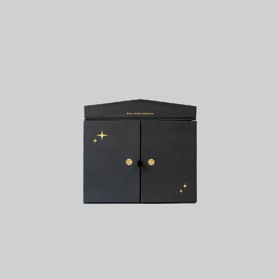 Animation of the Regalrose 12 Day Jewellery Advent Calendar opening. The doors part to reveal a red curtain and 12 numbered drawers, then the lid lifts to show an illustrated stage with two skeletons