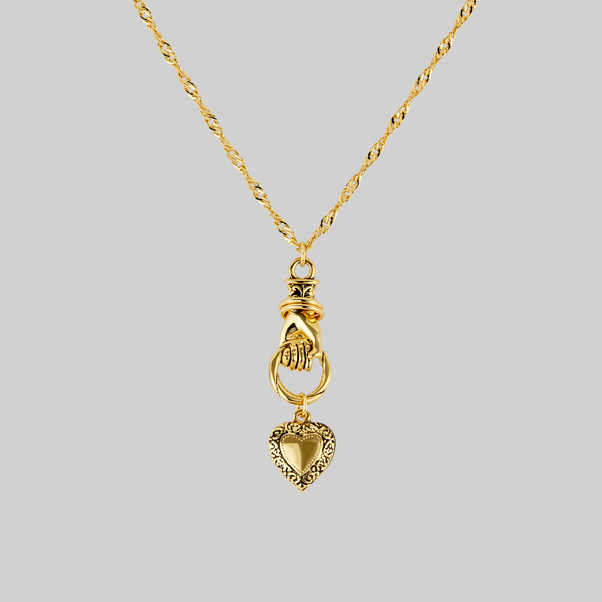 Hand and heart pendant necklace in gold
