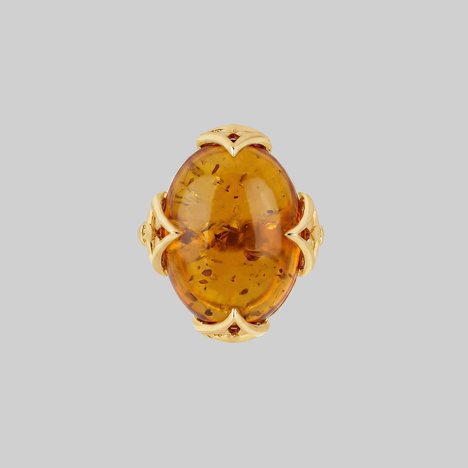 Large Amber cabochon gold ring with Gothic finishes