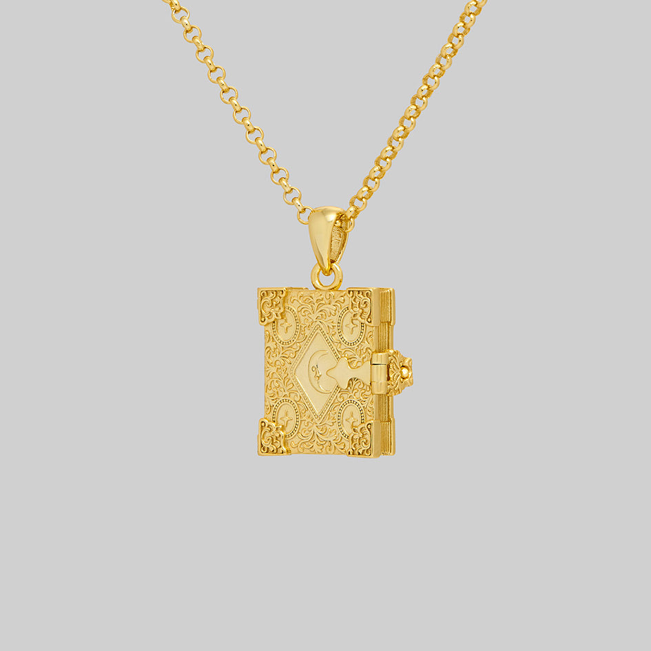Gold book of spells locket necklace, closed, angled view