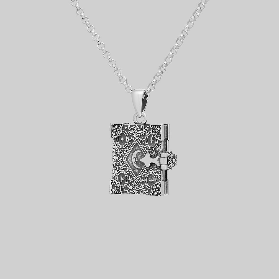 Silver book of spells locket necklace, closed, angled view