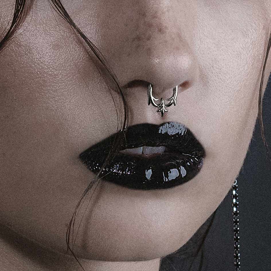Model wearing Hault silver heraldic lily septum clicker ring