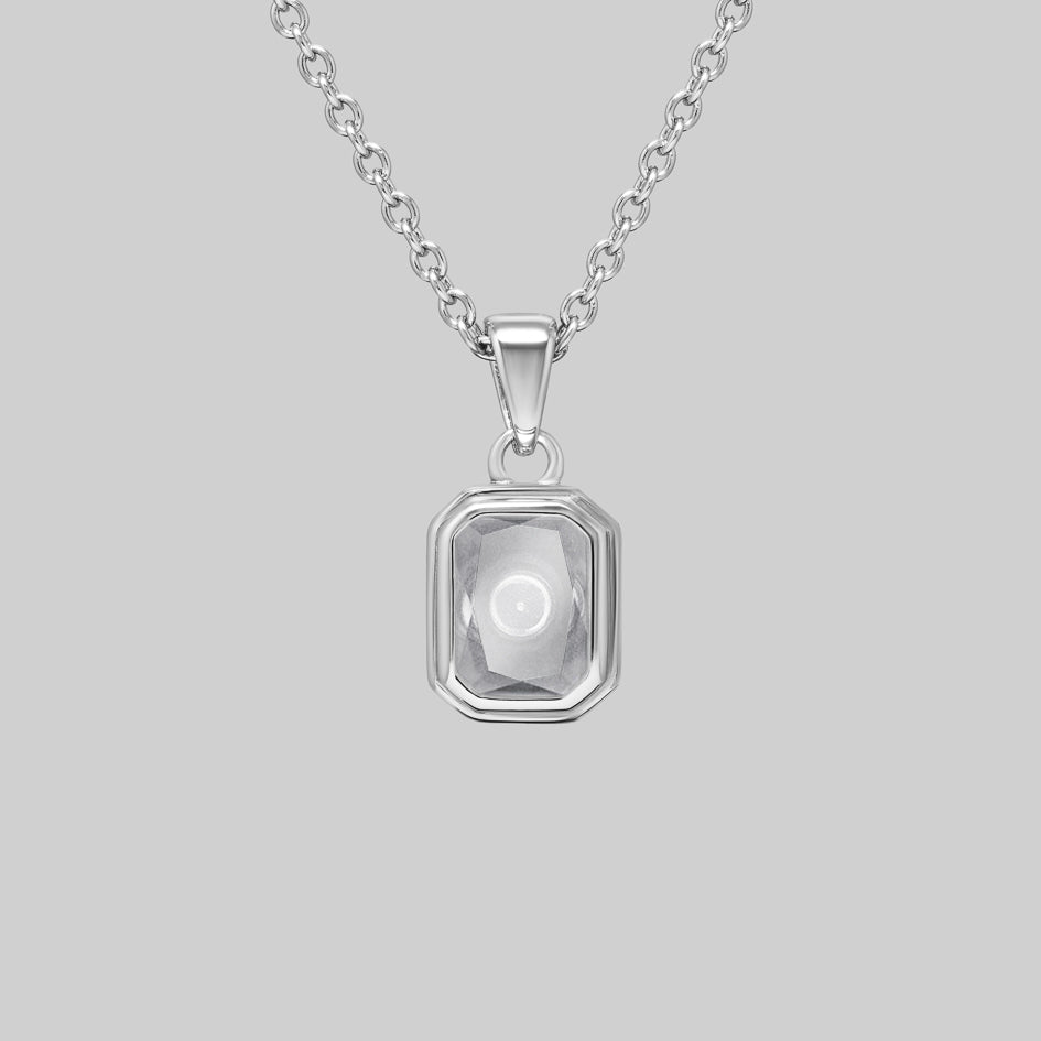 Sterling silver cremation necklace with an emerald cut Clear Quartz pendant, the ashes chamber visible through the stone