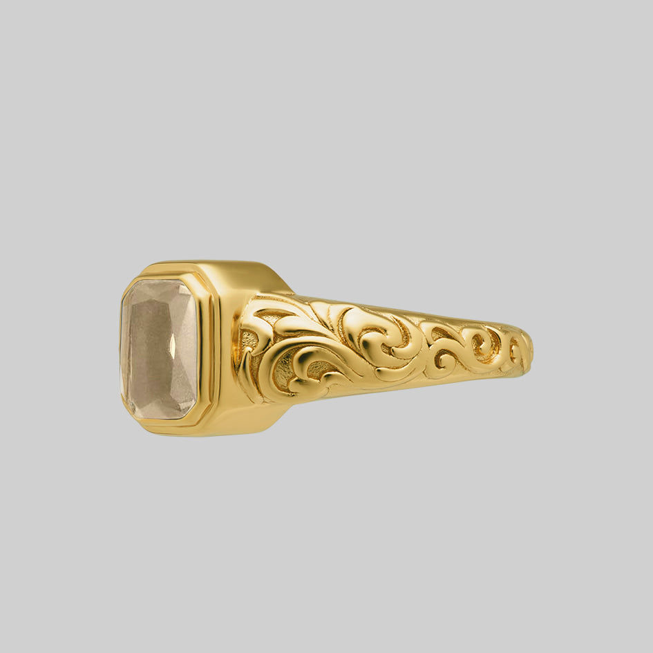 Side view of the gold Clear Quartz cremation ring showing the scroll engraving along the band