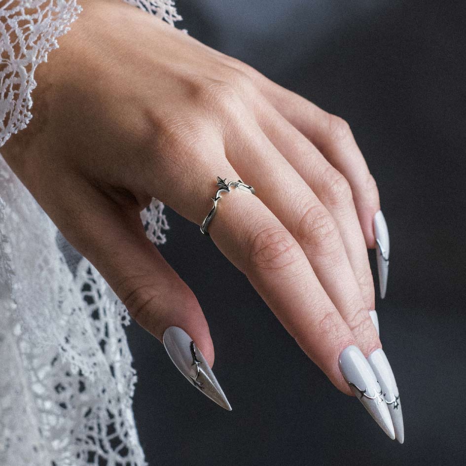 Model wearing Lisette silver heraldic lily chevron band