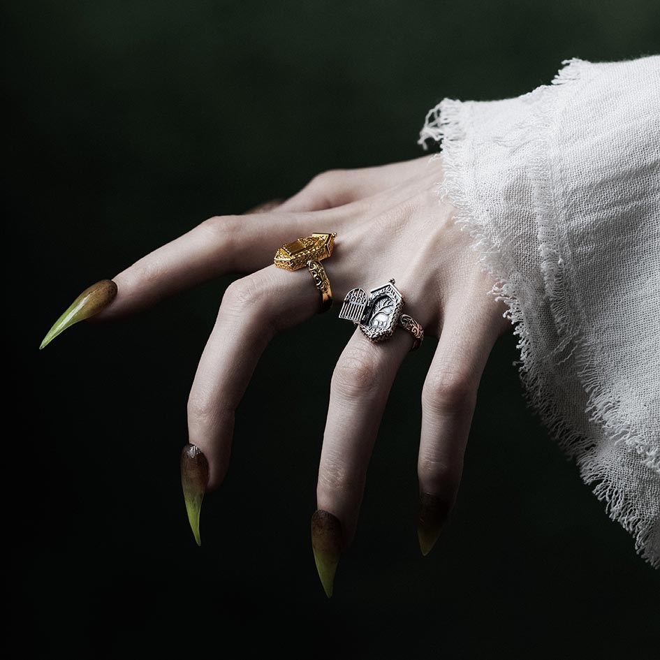 Model wearing gold and silver iron gate rings