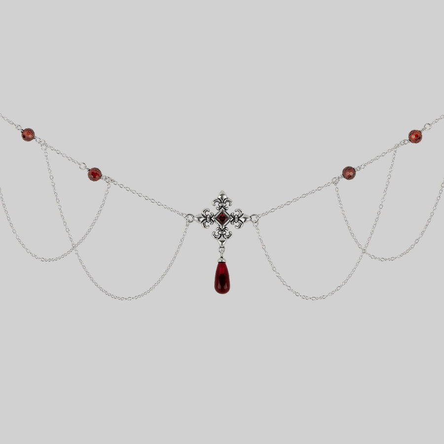 silver fleur-de-lis necklace with red gemstones