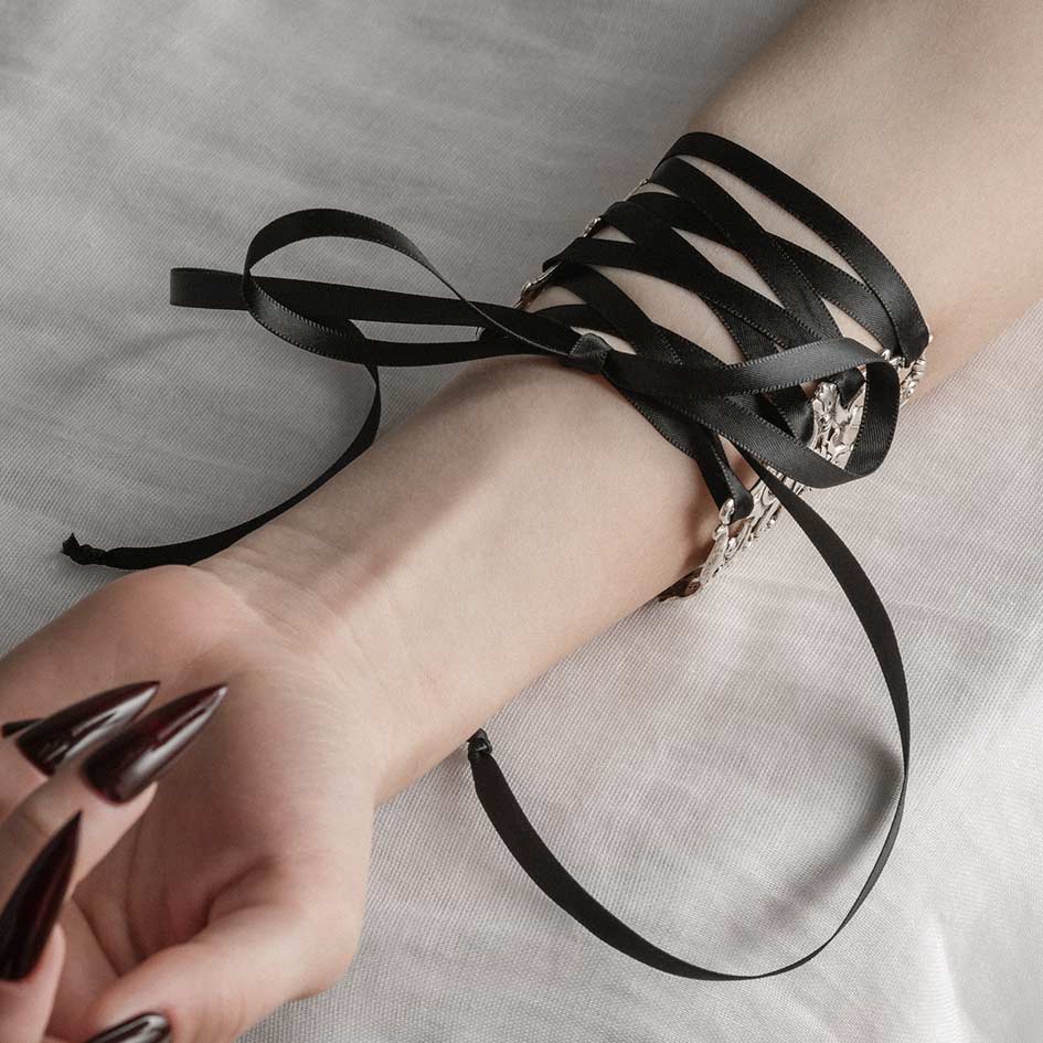 Decorative gothic cuff bracelet with black lace tie detail
