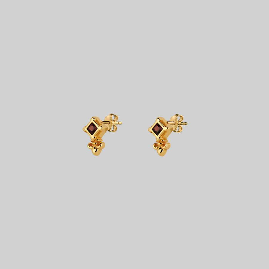 SCORN. Tiny Garnet Stud Earrings - Gold gold small fleur-de-lis garnet stud earrings