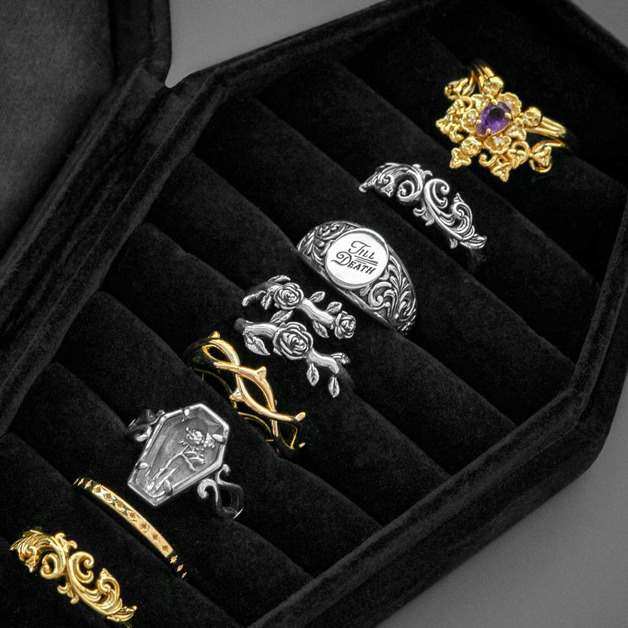 The Black Velvet Coffin Ring Case black velvet coffin case with silver gold rings close up