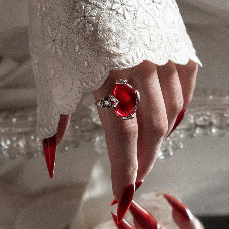 large red cabochon statement ring with fleur de lis