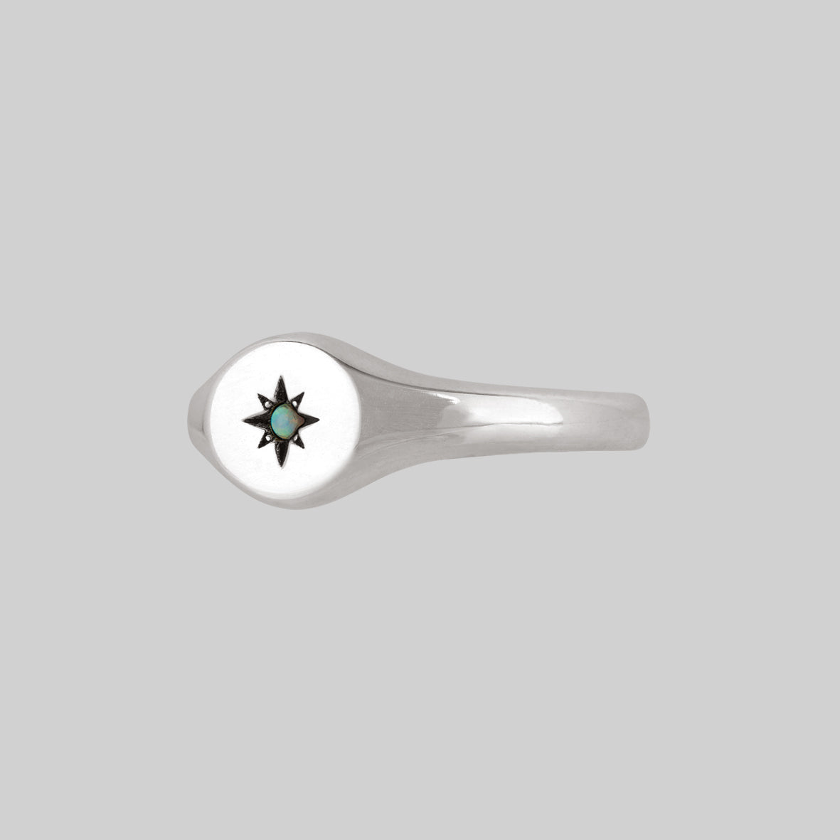 oval silver signet ring with star set opal