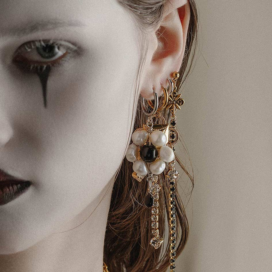 LILLIAN. Pearl Daisy Hoop Earrings - Gold model wearing a mixture of gold and silver ornate gothic jewellery