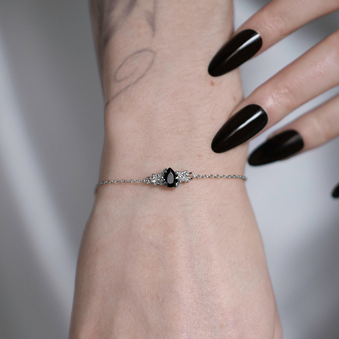 silver black onyx gemstone dainty bracelet with gothic detail edgy jewellery