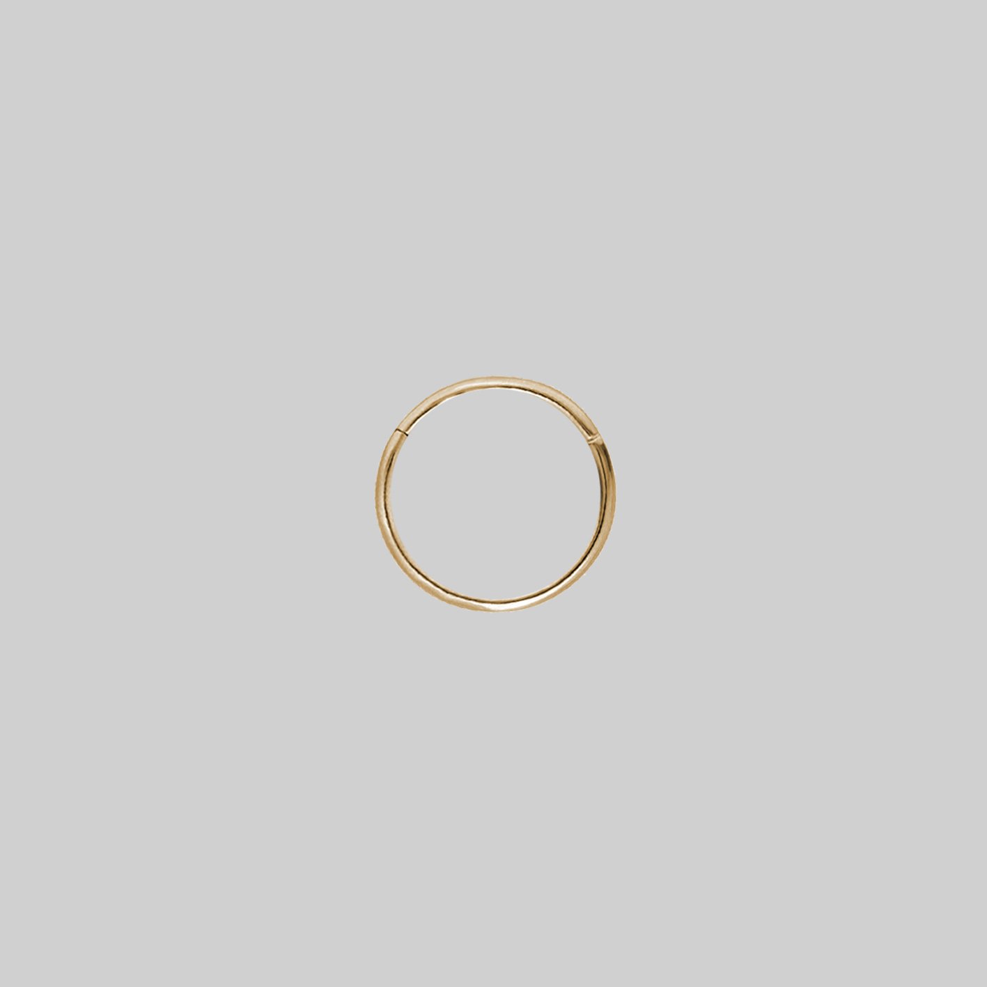 A small gold clicker ring with a simple design 10mm x 0.8mm