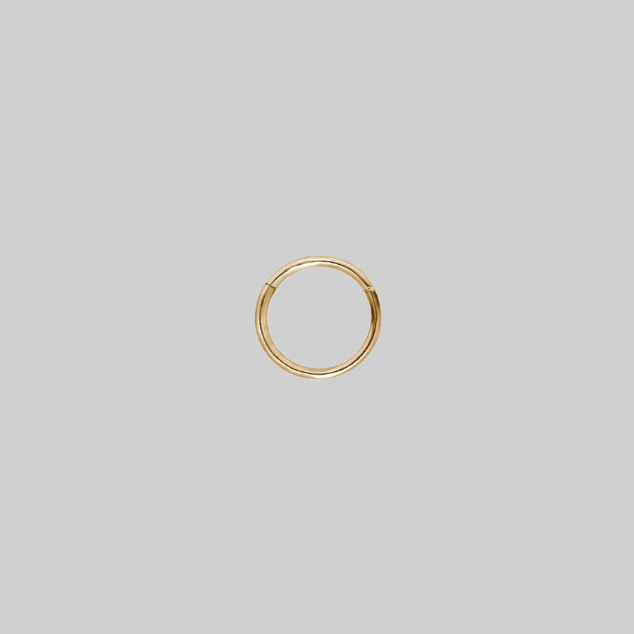 LARA. Gold Titanium Clicker Ring A small gold clicker ring with a simple design 1.2mm