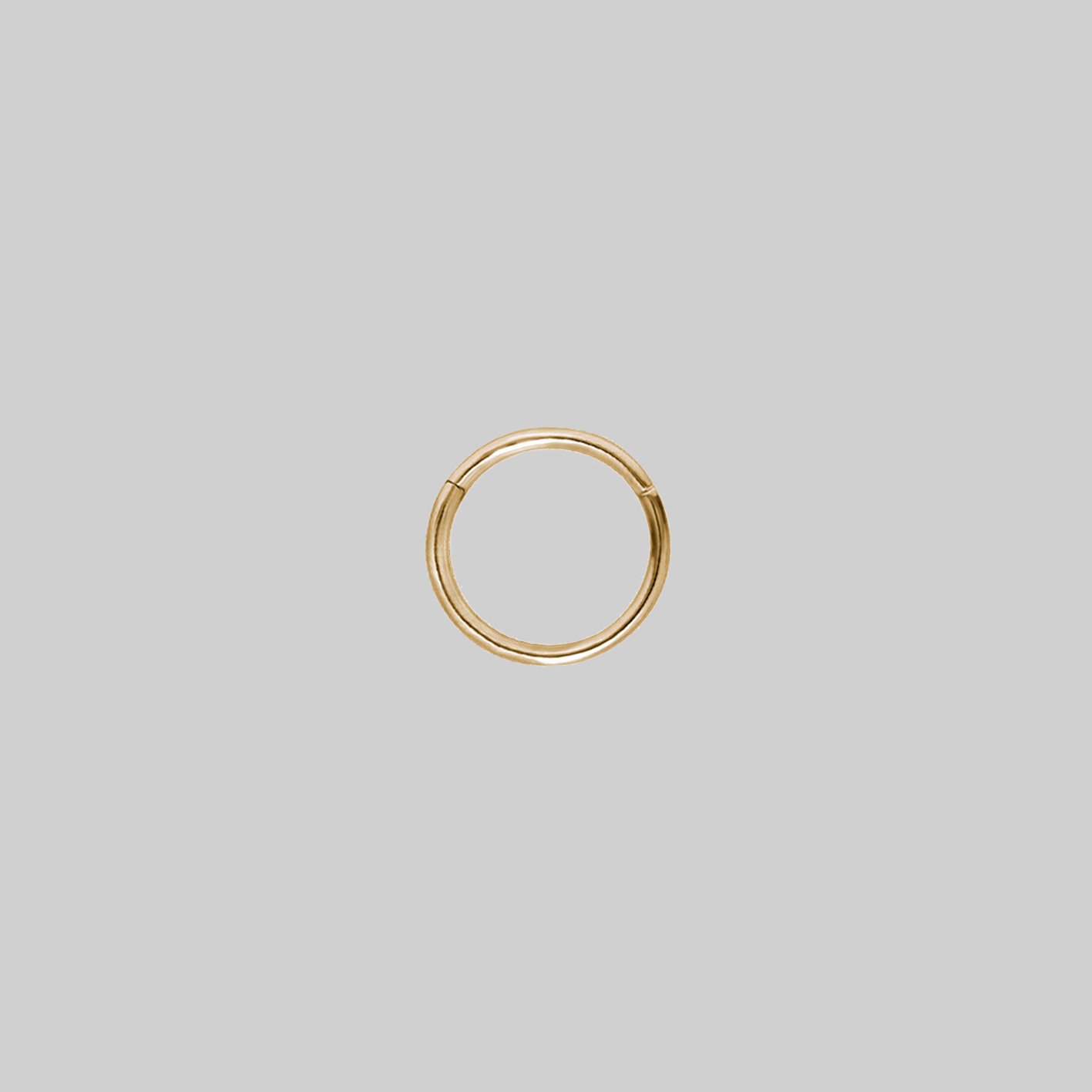 A small gold clicker ring with a simple design 8mm x 1.2mm