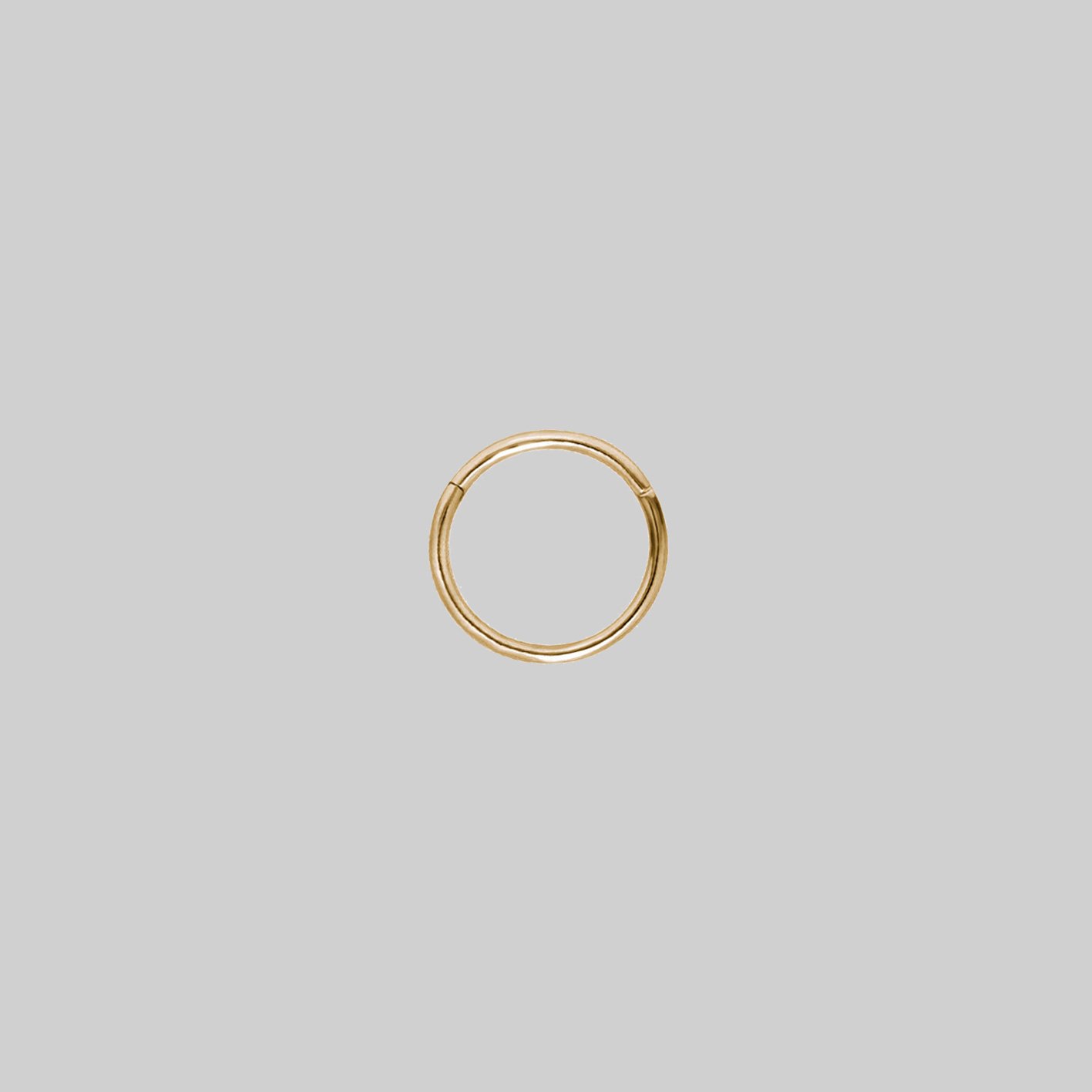 A small gold clicker ring with a simple design 8mm x 1mm