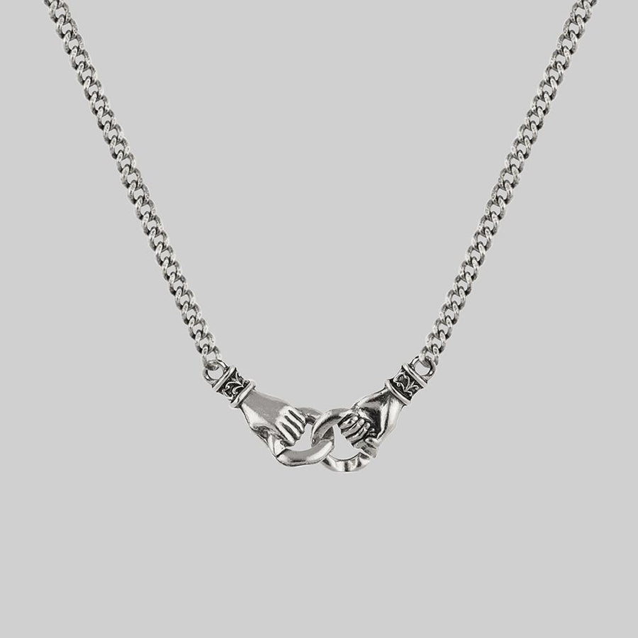 Hands-holding-silver-necklace