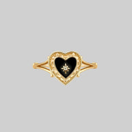 gold ring with black heart