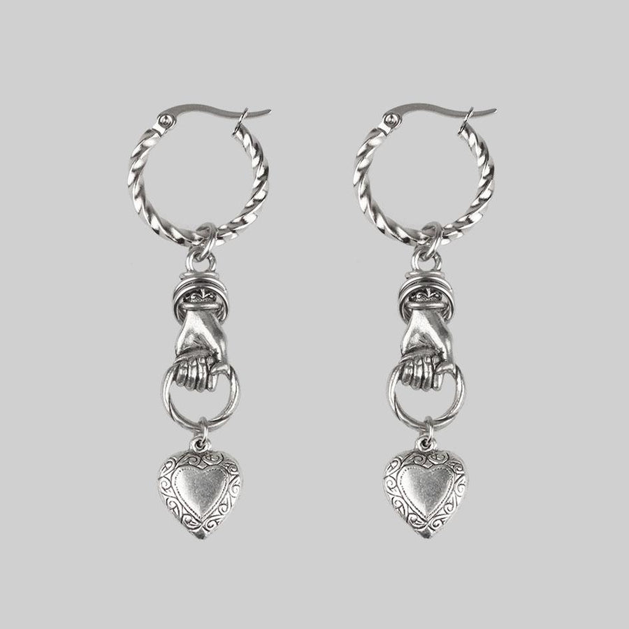 ALL OF ME. Hand Grasping Heart Earrings - Silver