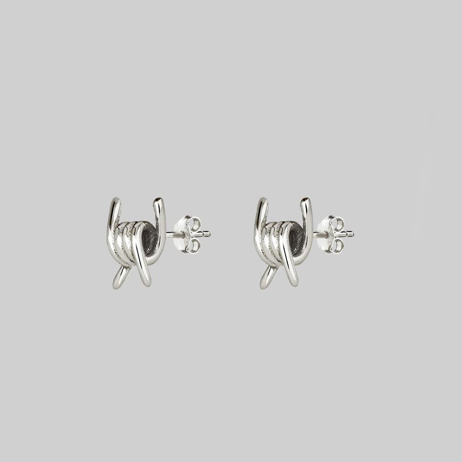 SURVIVAL. Symbolic Barbed Wire Stud Earrings - Silver barbed wire knot stud earrings