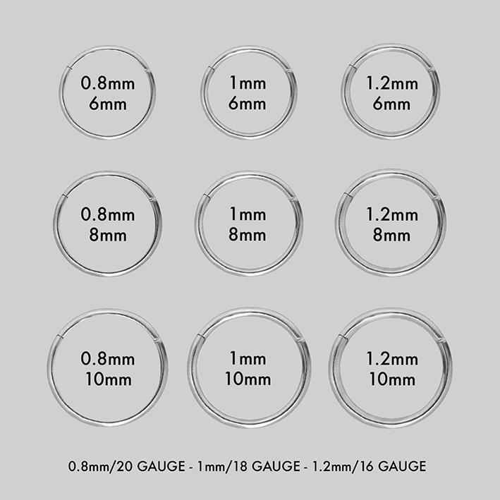 MIA. Silver Titanium Clicker Ring group picture of silver clicker rings and their sizing