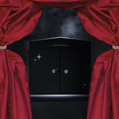 Black Regalrose advent calendar box with closed doors and silver stars, framed by red theatre curtains