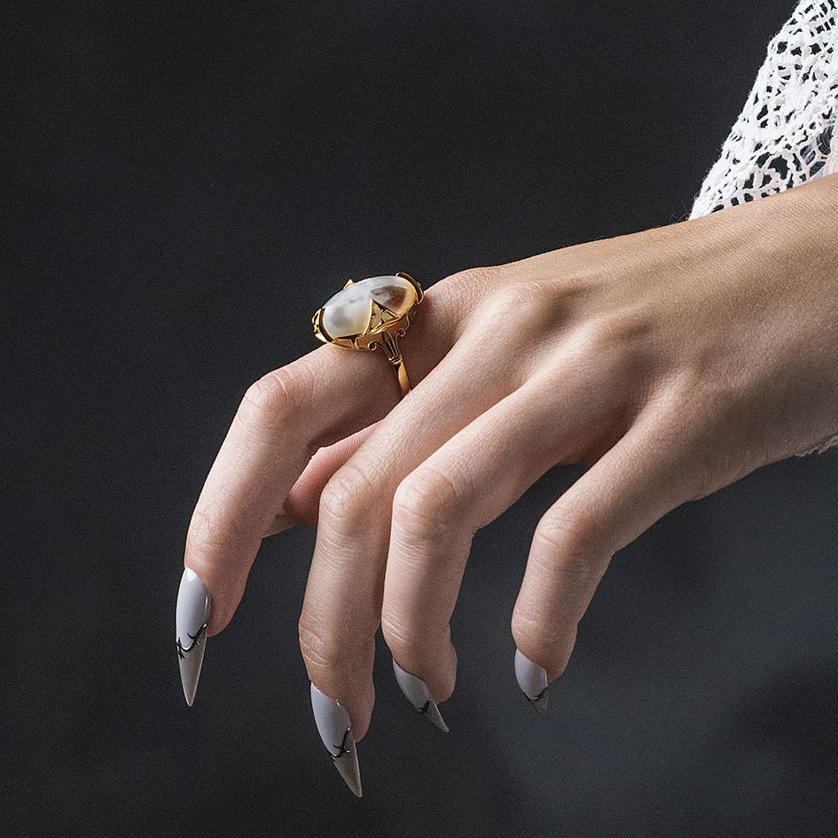 Model wearing Circinus gold gothic pearl ring, side view