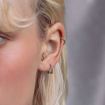 model wearing the silver barbell ring in her ear