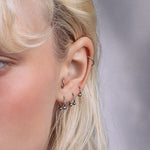 model wearing silver barbell multipack earrings