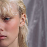 barbell titanium ring worn as an ear piercing by a model