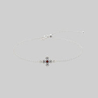 Silver dainty bracelet with a garnet stone and decorative clasp