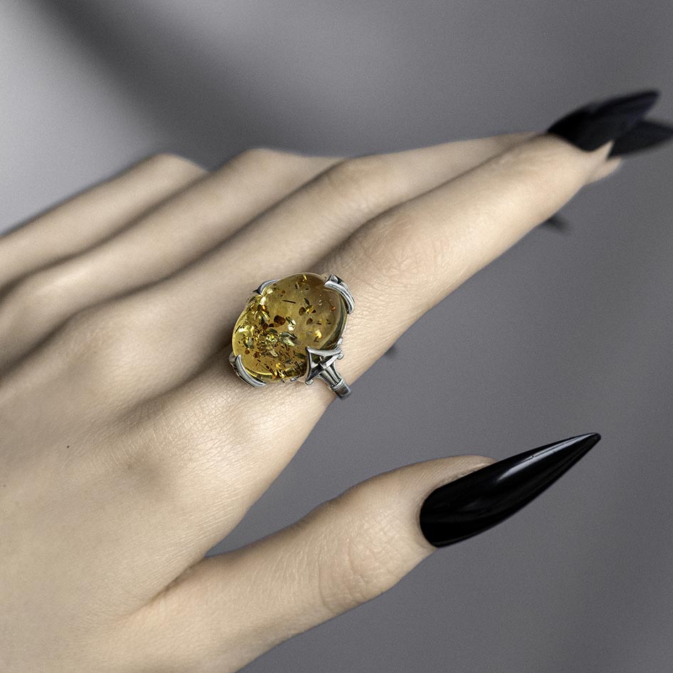 Amber Cabochon ring, features inclusions and an intricate gothic style setting. 
