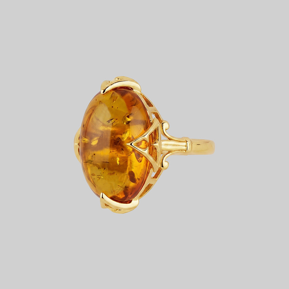 Large Amber cabochon gold ring with Gothic finishes