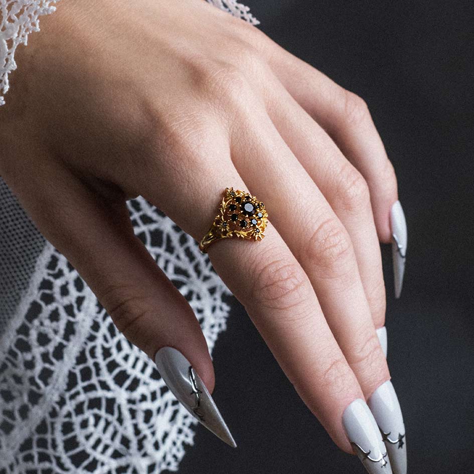 Black onyx cluster gold ring with heraldic detail