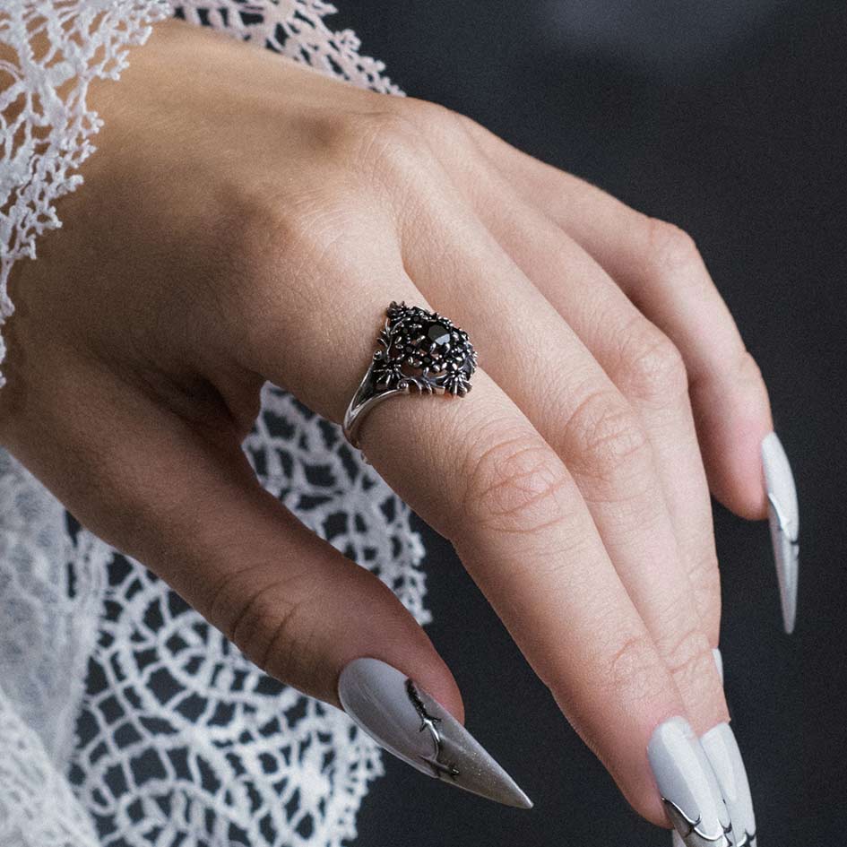 Model wearing Estienne silver heraldic lily black onyx cluster ring