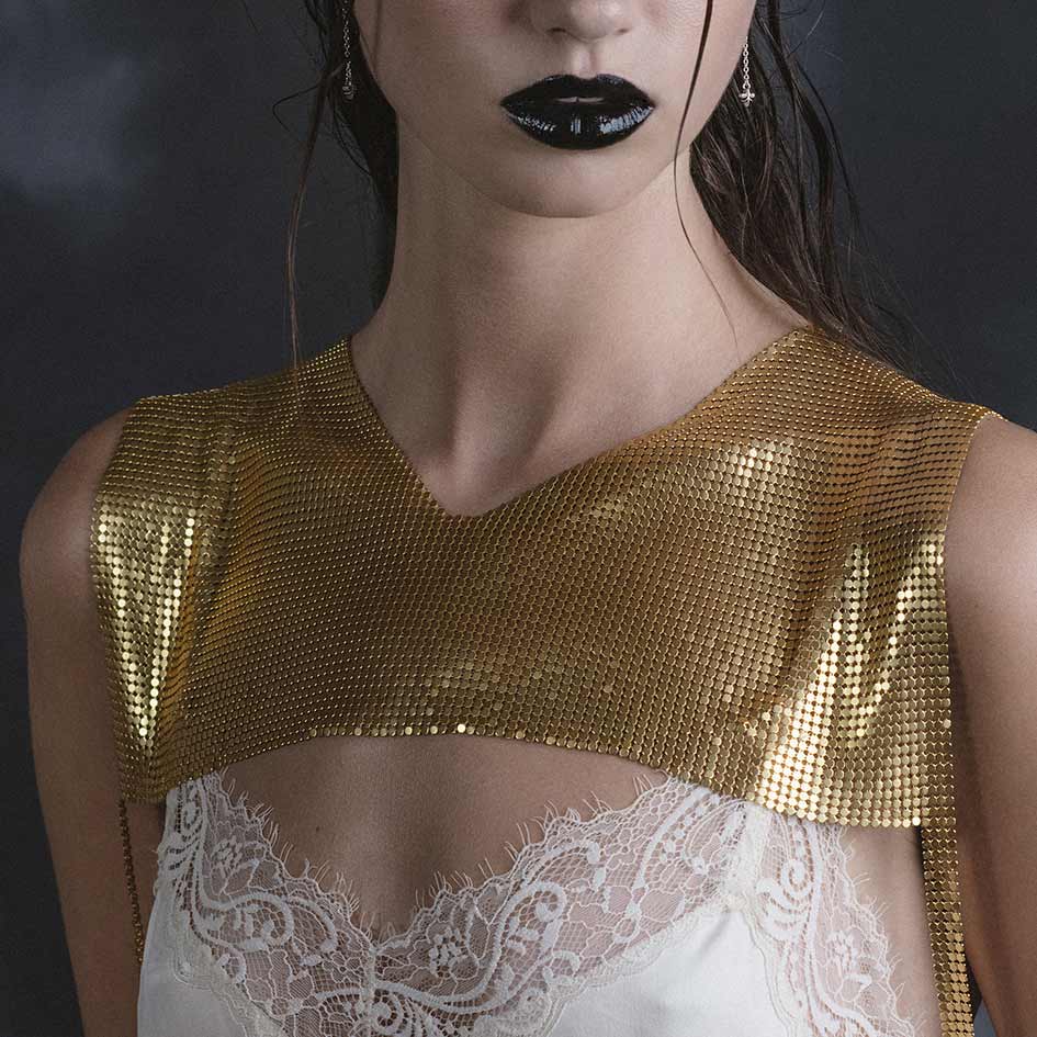 Model wearing Faust gold armoured breastplate