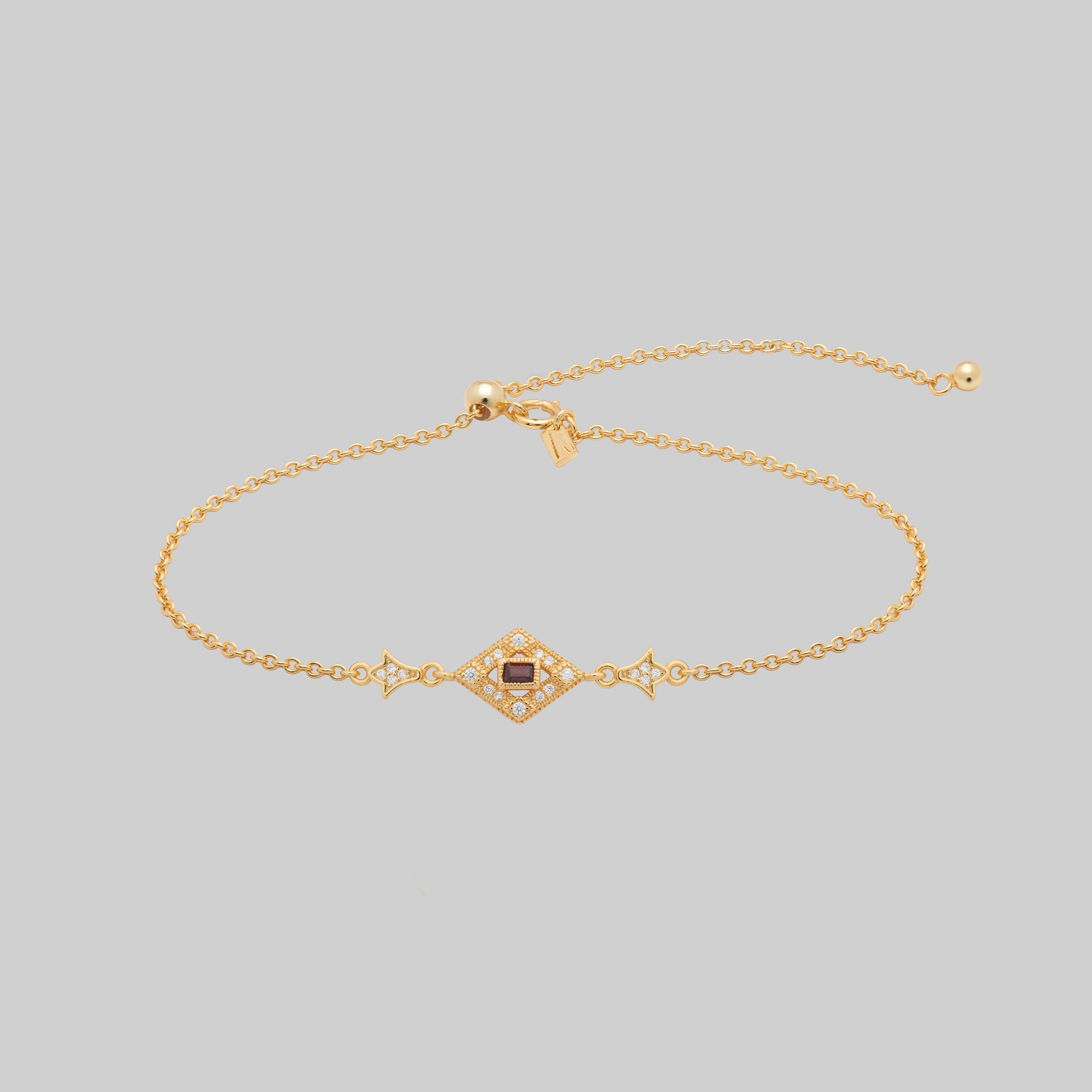 gold dainty bracelet with red gemstone in a decorative 20s style