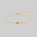 gold dainty bracelet with red gemstone in a decorative 20s style