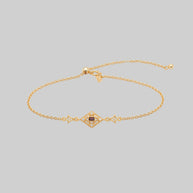 gold dainty bracelet with red gemstone in a decorative 20s style