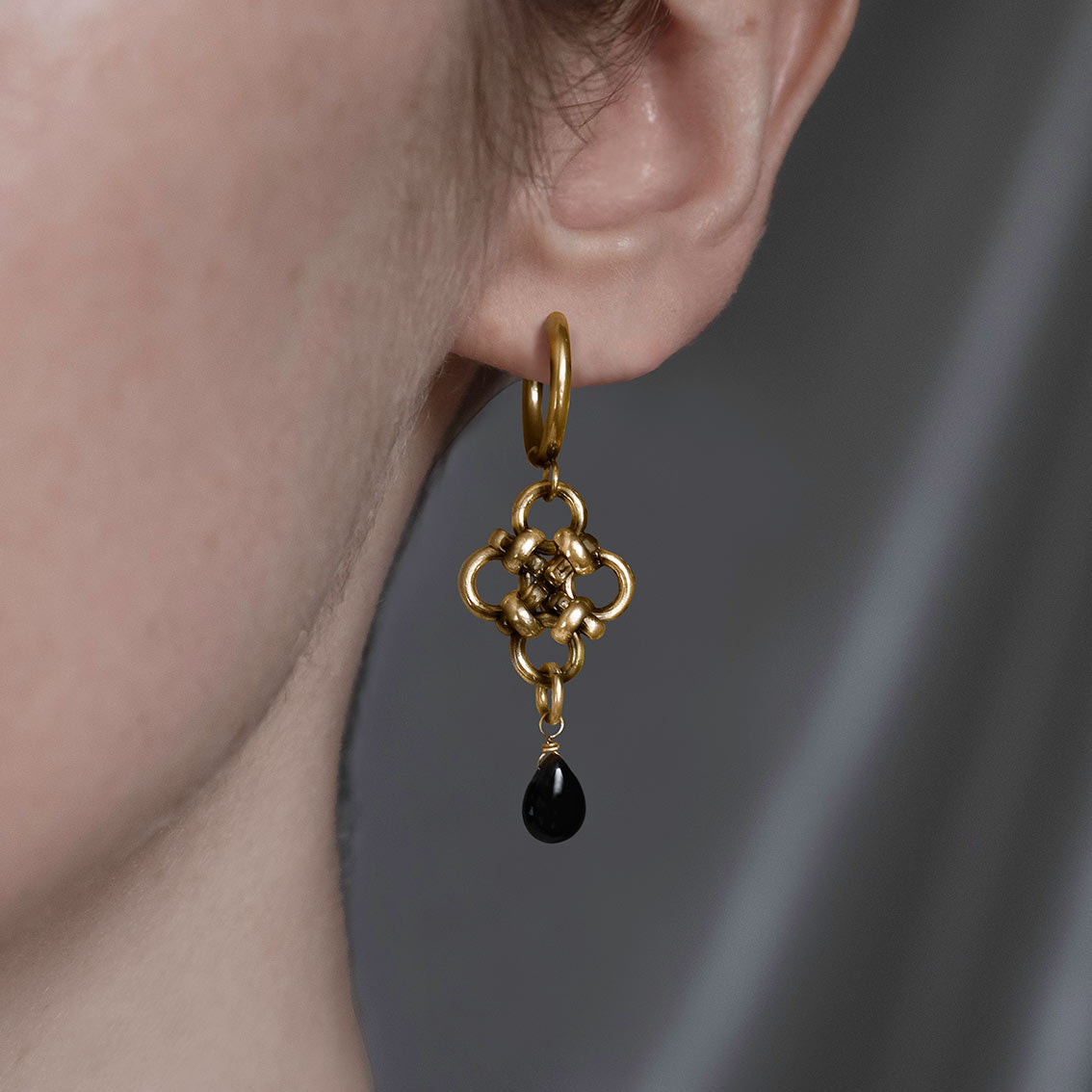 Gold knotted hoop earrings with black agate 