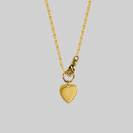 hand holding heart necklace gold
