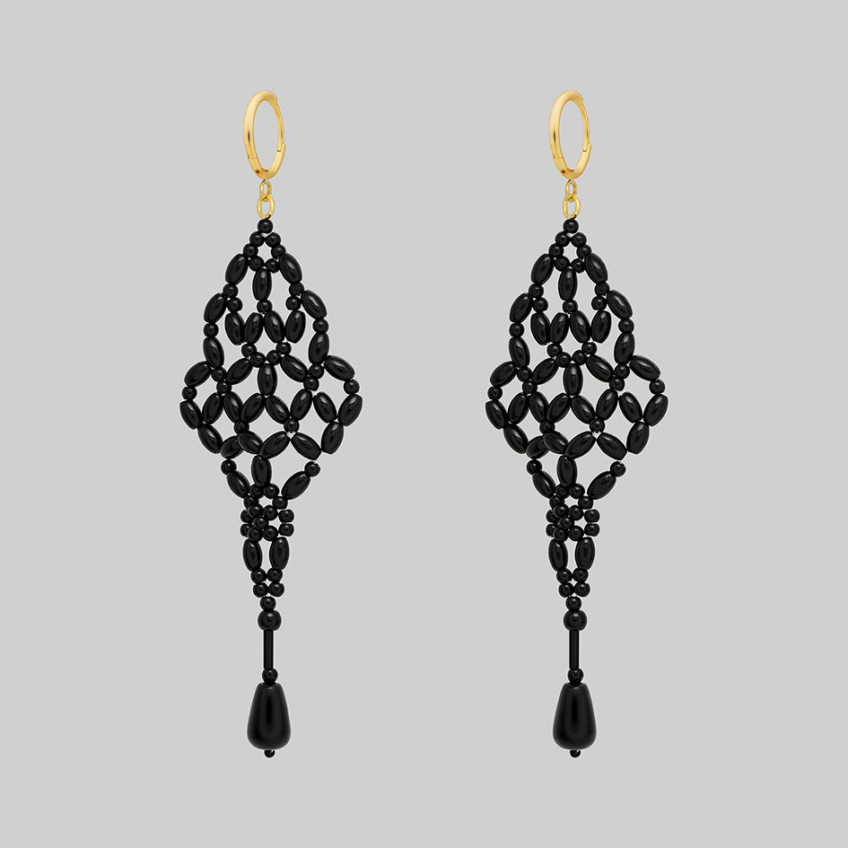 Black beaded chandelier drop earrings with gold hoops, side view