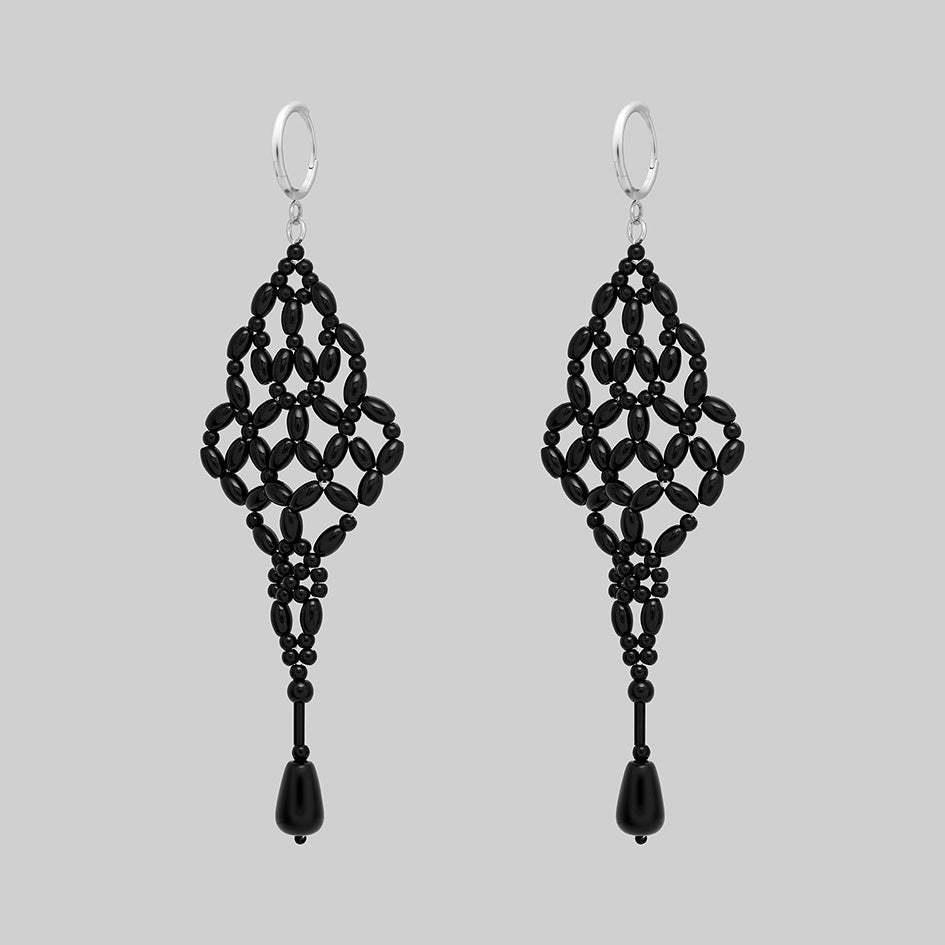 Black beaded chandelier drop earrings with silver hoops, side view