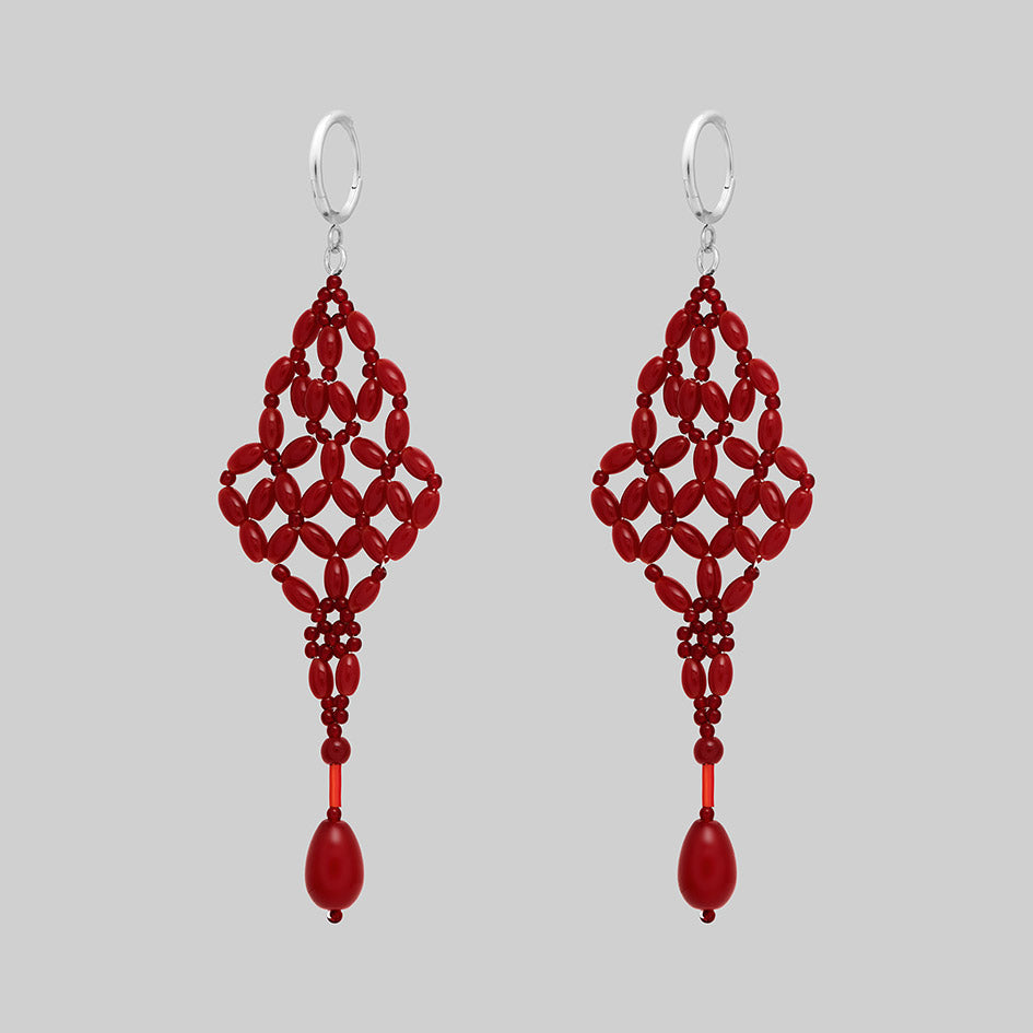 Red beaded chandelier drop earrings with silver hoops, alternative angle