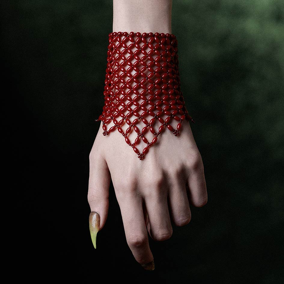 Model wearing red beaded corset cuff, front view over the hand