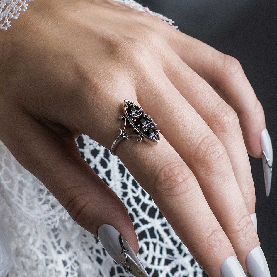 Model wearing Heloise silver heraldic lily black onyx ring