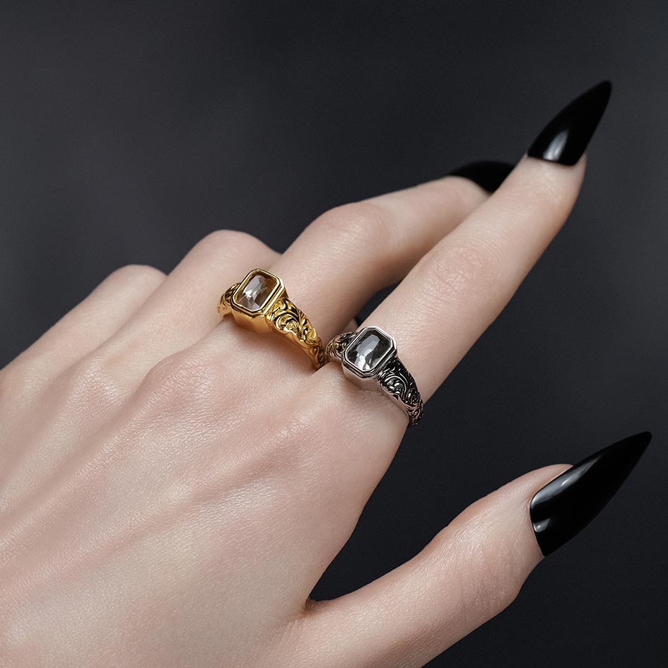 Gold and sterling silver Clear Quartz cremation rings with scroll engraved bands, styled together