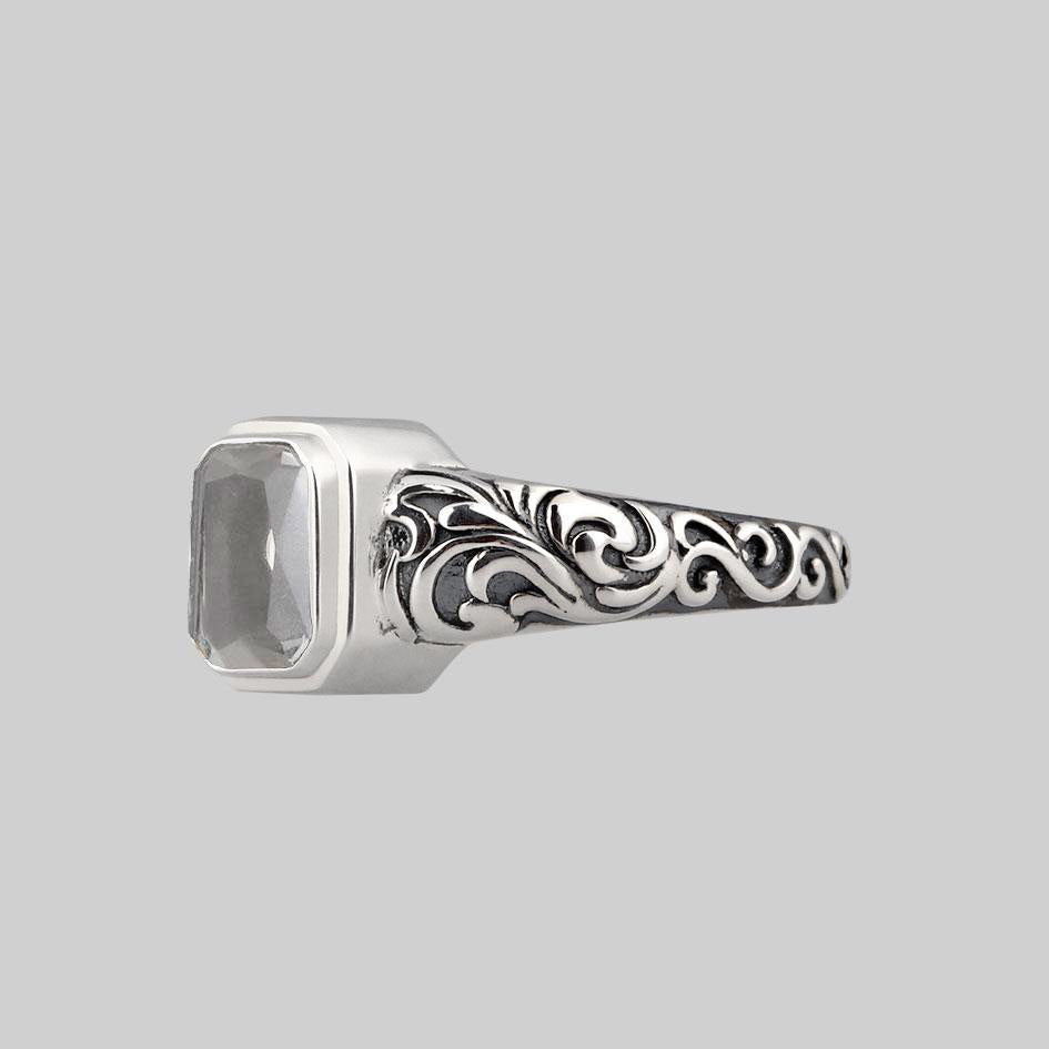 Side view of the sterling silver Clear Quartz cremation ring showing the oxidised scroll engraving along the band
